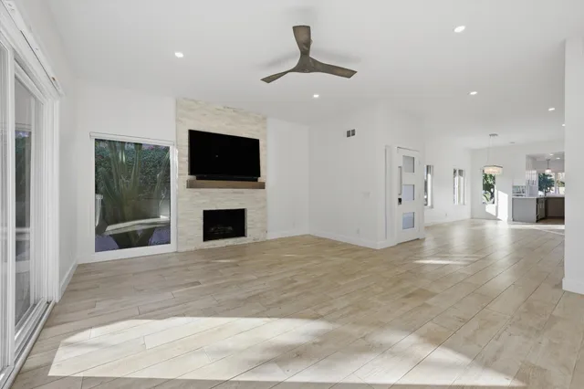 a view of a livingroom with a fireplace a fireplace and a window