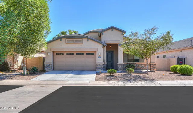 a front view of a house with garage