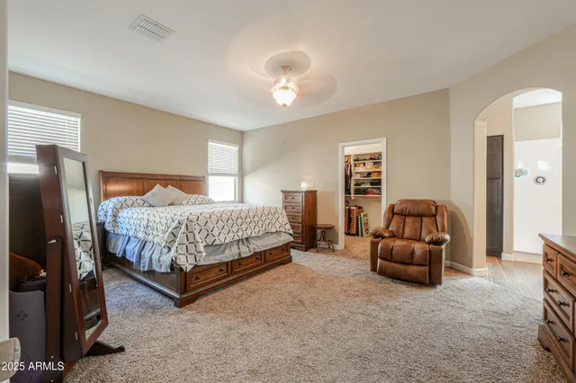 a bedroom with a large bed and a tv