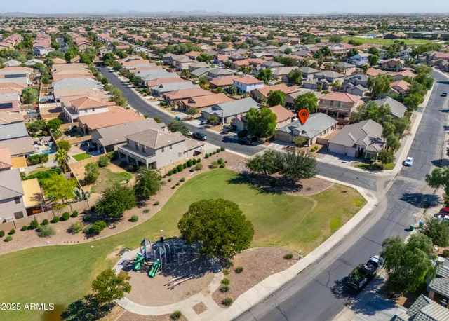 an aerial view of a house with yard and patio