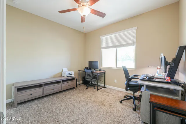 a view of a workspace with furniture and a window