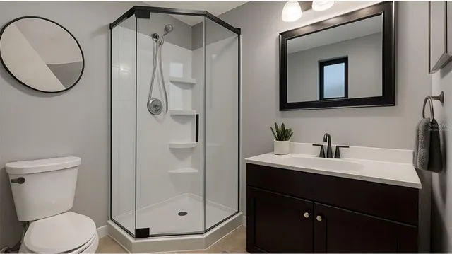 a bathroom with a toilet sink vanity and mirror