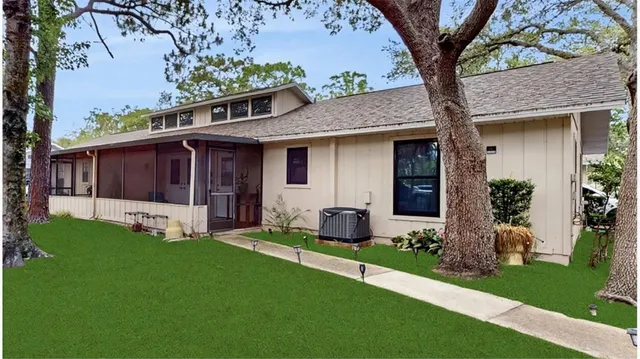 a front view of a house with a garden and yard