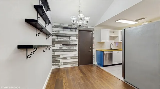 a view of a kitchen with a sink and refrigerator