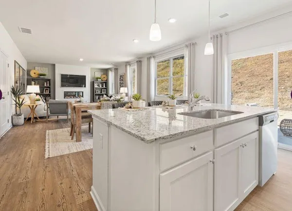 a kitchen with center island with sink appliances and cabinets