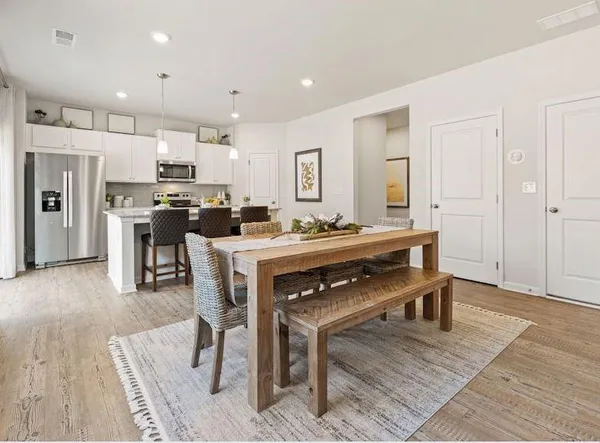 a view of kitchen with cabinets table and chairs