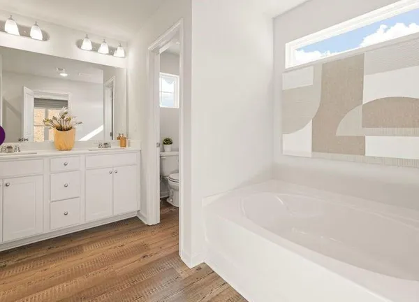 a bathroom with a bathtub and a sink