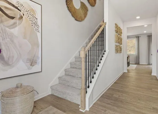 a view of entryway and hall with wooden floor