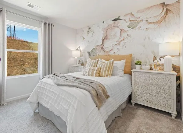 a bedroom with a bed and window