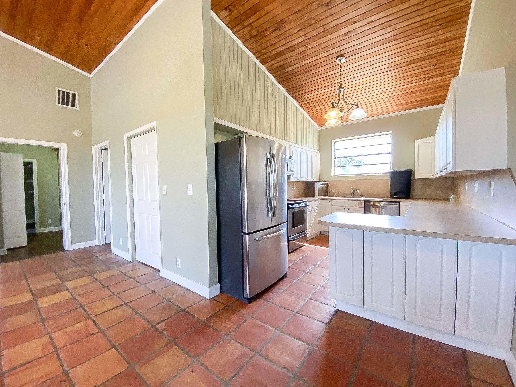 3715 Flying Cow Ranch Road Wellington, FL 33470 - Photo 18 of 33 a kitchen with stainless steel appliances a refrigerator and a sink