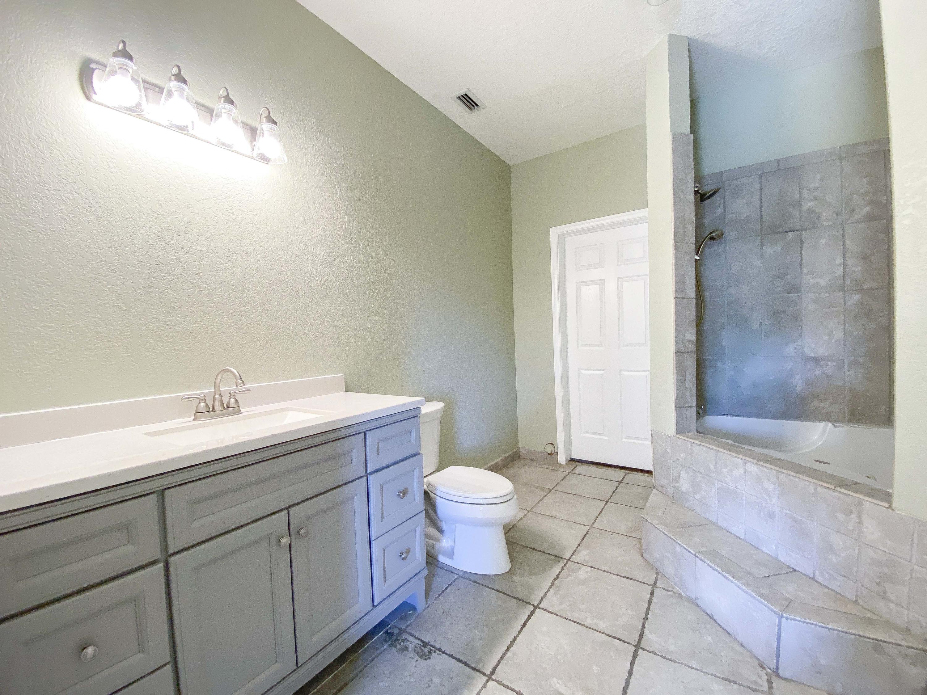 3715 Flying Cow Ranch Road Wellington, FL 33470 - Photo 21 of 33 a bathroom with a sink and a toilet