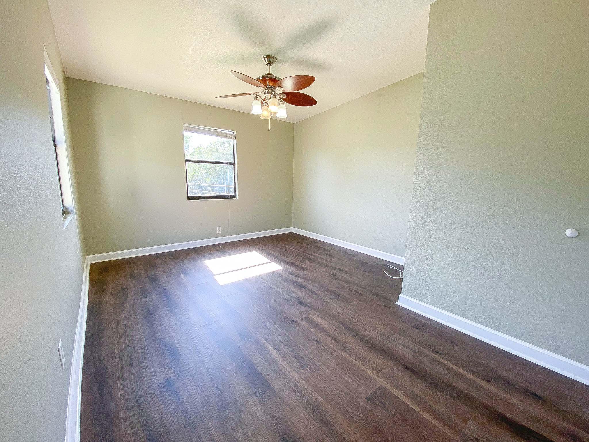 3715 Flying Cow Ranch Road Wellington, FL 33470 - Photo 26 of 33 wooden floor in an empty room with a window