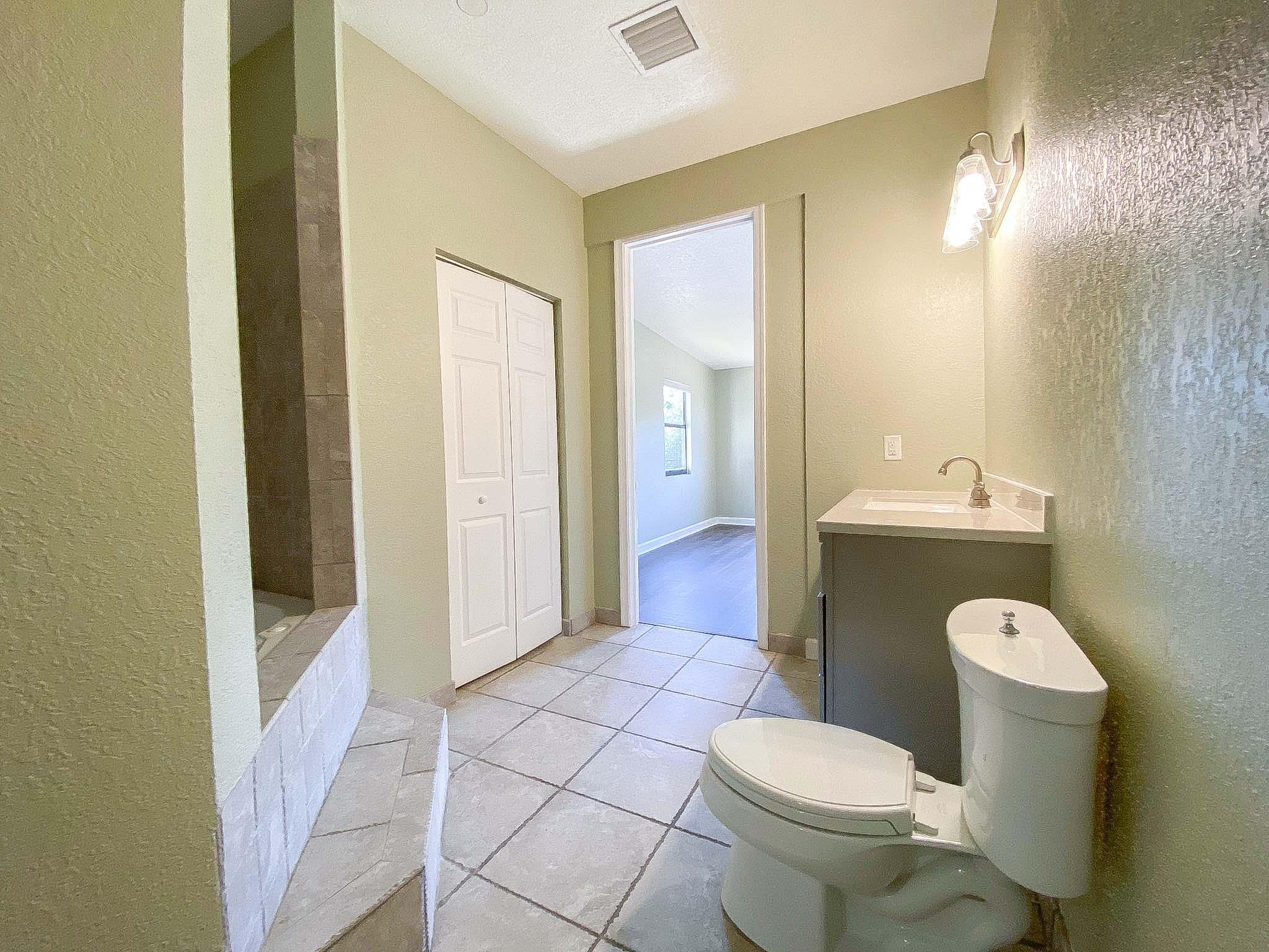 3715 Flying Cow Ranch Road Wellington, FL 33470 - Photo 27 of 33 a bathroom with a sink toilet and shower