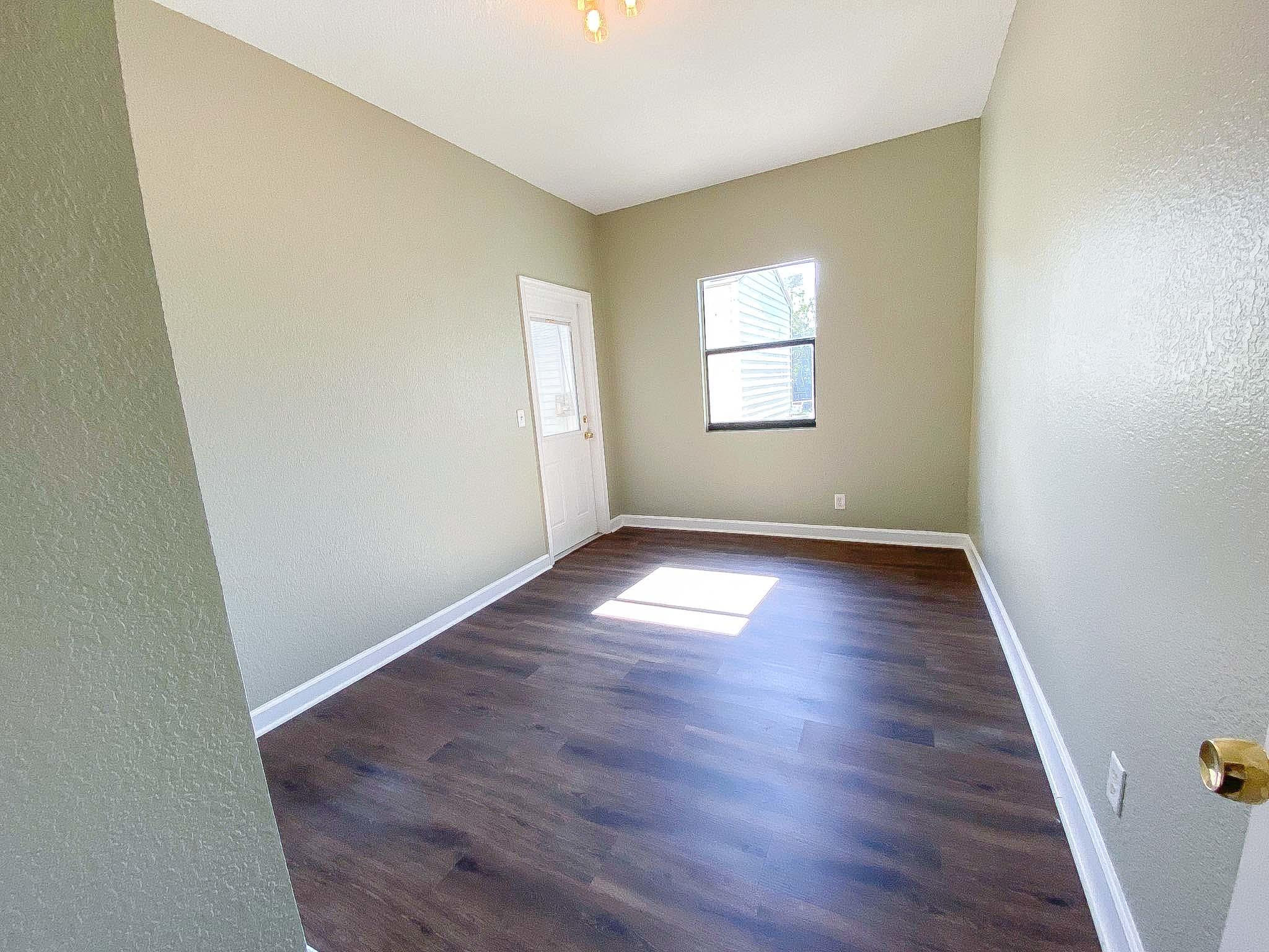 3715 Flying Cow Ranch Road Wellington, FL 33470 - Photo 31 of 33 an empty room with wooden floor and windows