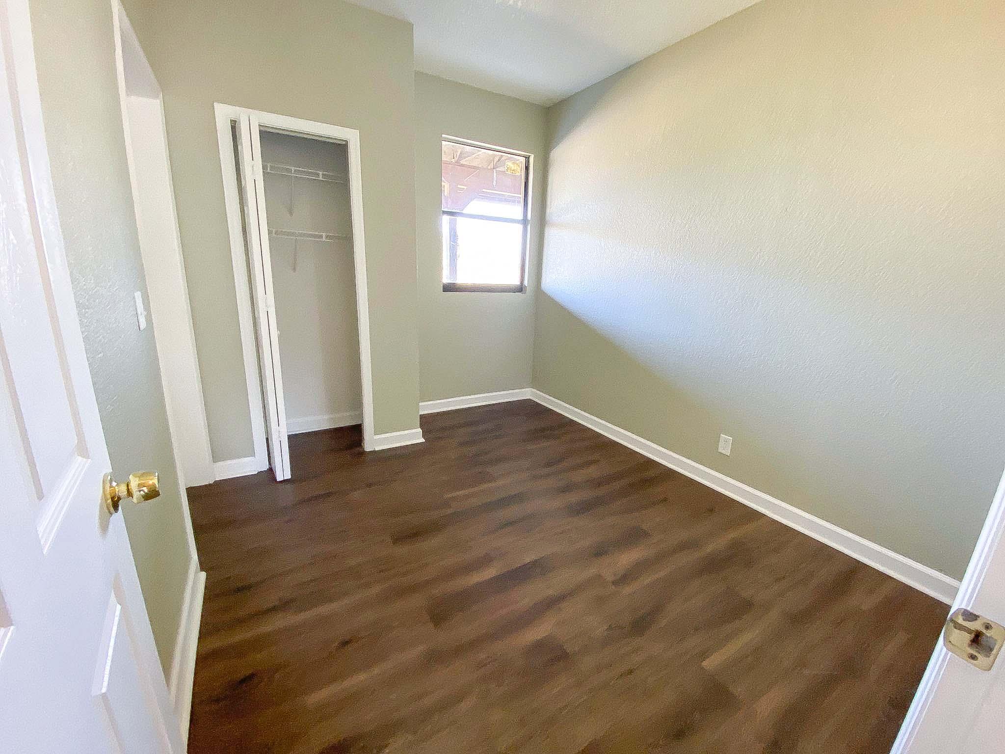 3715 Flying Cow Ranch Road Wellington, FL 33470 - Photo 33 of 33 an empty room with wooden floor and windows