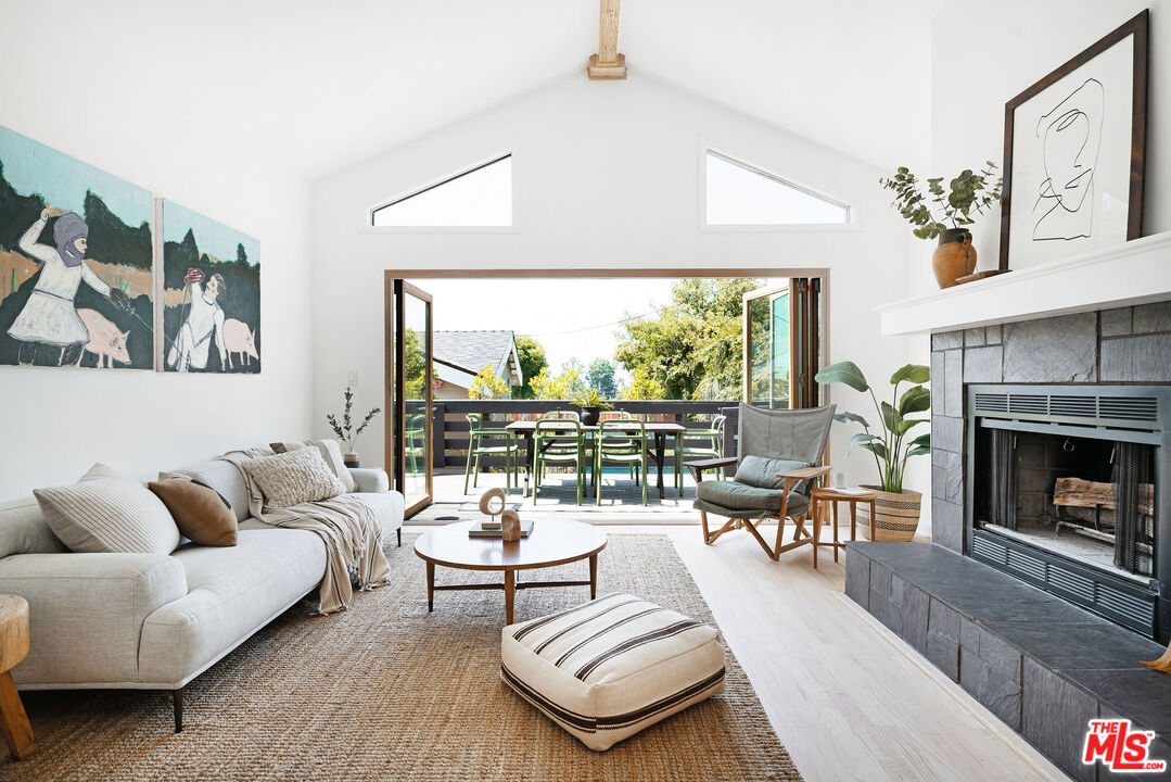230 Marathon Road Altadena, CA 91001 - Photo 13 of 46 a living room with furniture fireplace and a large window