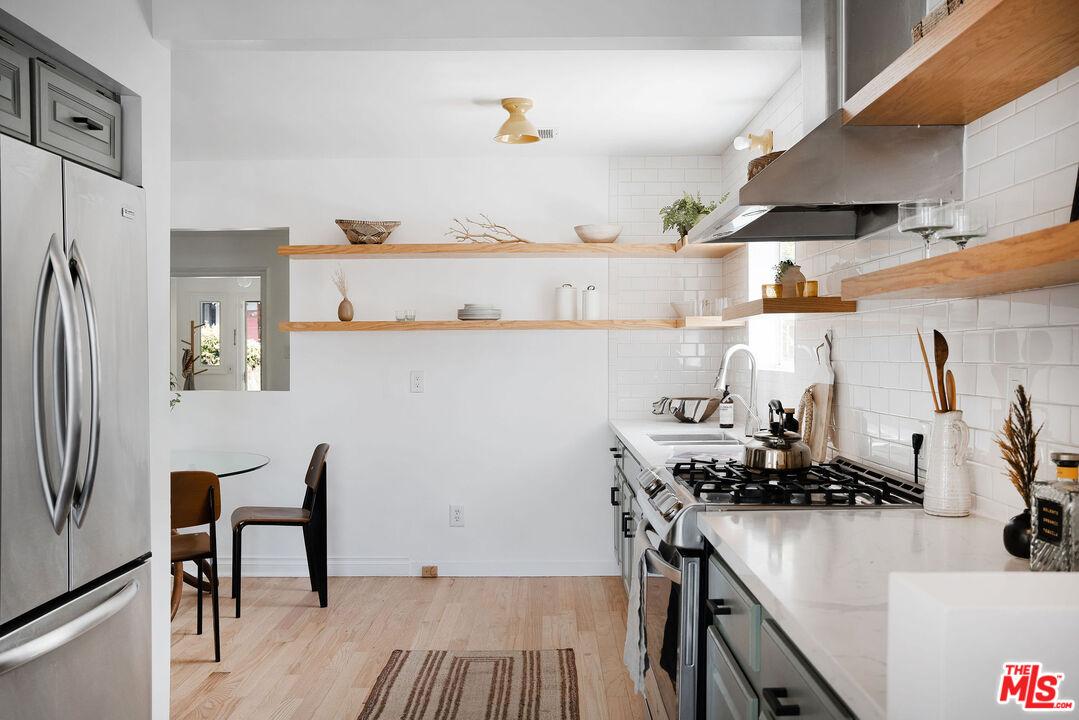 230 Marathon Road Altadena, CA 91001 - Photo 9 of 46 a kitchen with stainless steel appliances granite countertop a refrigerator and a stove top oven