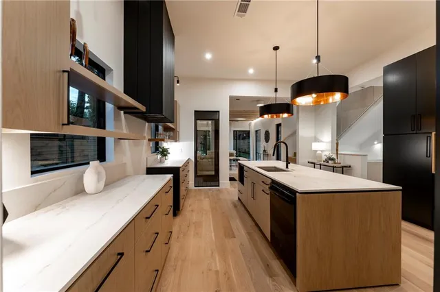 a kitchen with stainless steel appliances kitchen island a large island in the center