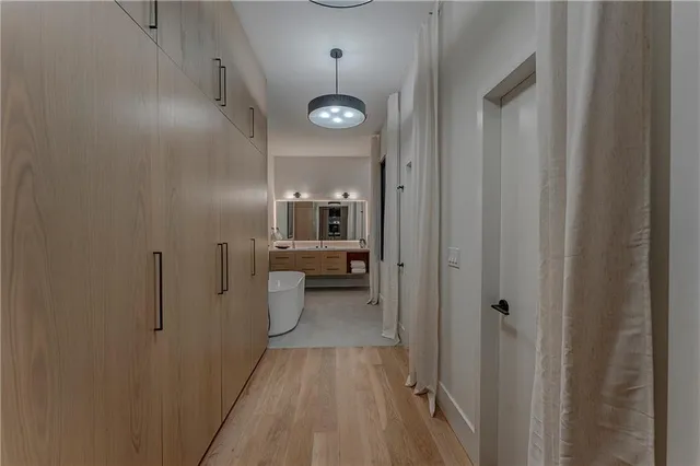 a bathroom with a bathtub sink and mirror