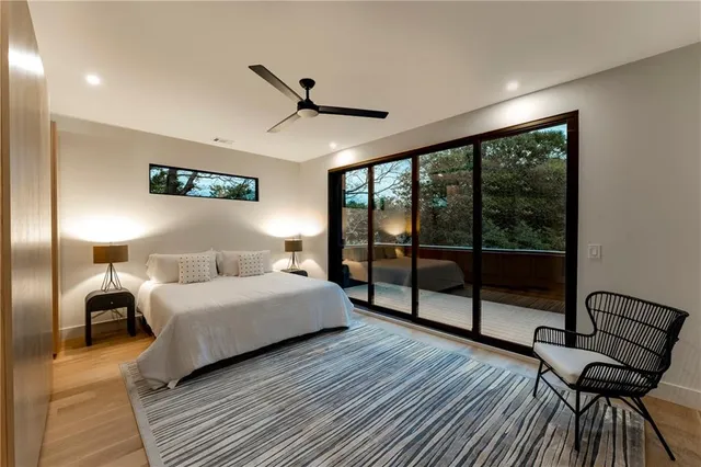 a view of an empty room with glass door and a window