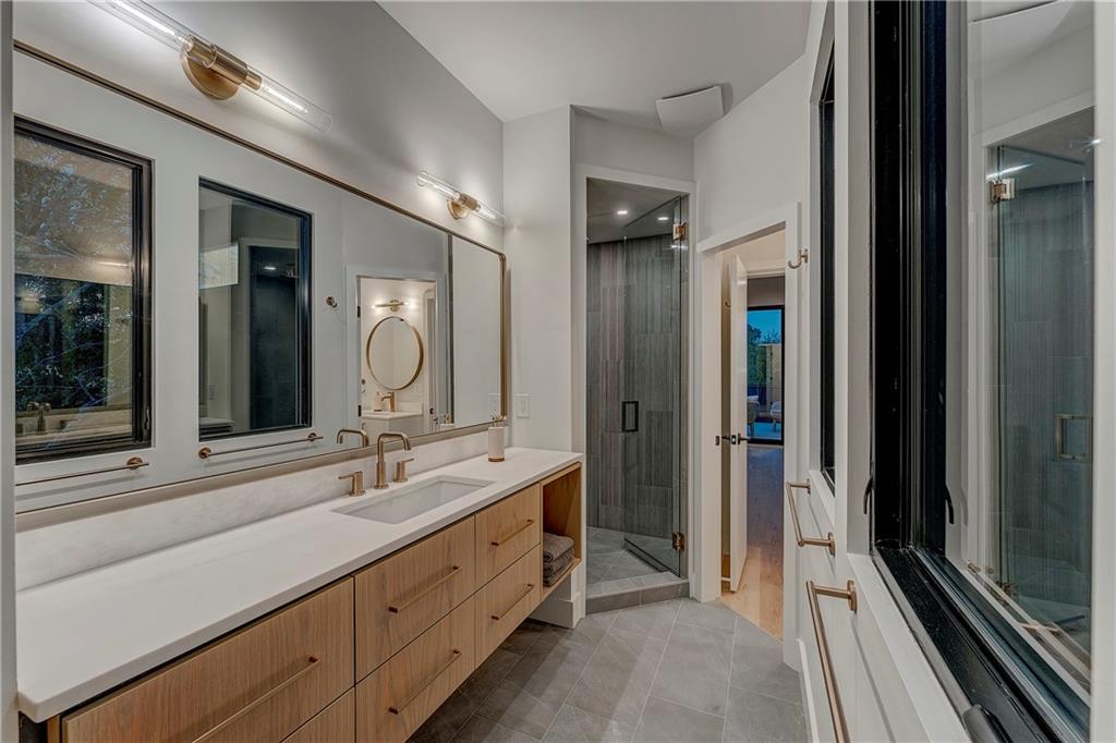 787 Bonaventure Avenue Northeast Atlanta, GA 30306 - Photo 37 of 64 a bathroom with a double vanity sink and a mirror