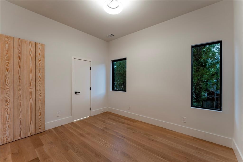 787 Bonaventure Avenue Northeast Atlanta, GA 30306 - Photo 41 of 64 a view of an empty room with wooden floor and a window
