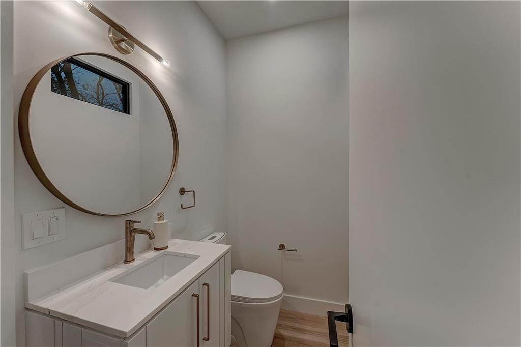 787 Bonaventure Avenue Northeast Atlanta, GA 30306 - Photo 49 of 64 a bathroom with a toilet sink vanity and mirror