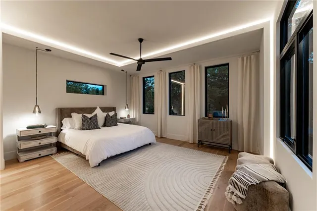 a bedroom with double bed and a chandelier