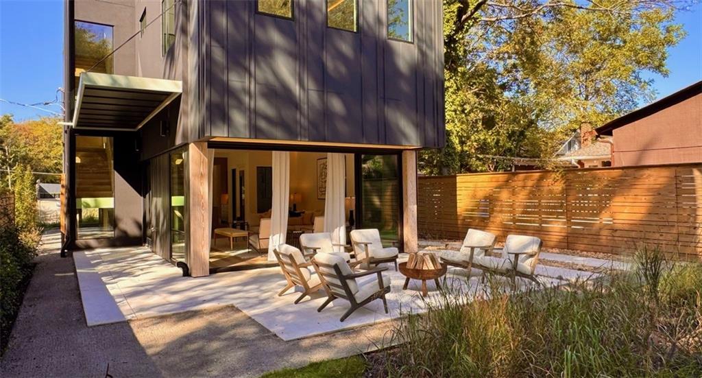 787 Bonaventure Avenue Northeast Atlanta, GA 30306 - Photo 64 of 64 a view of a patio with table and chairs with wooden floor and fence