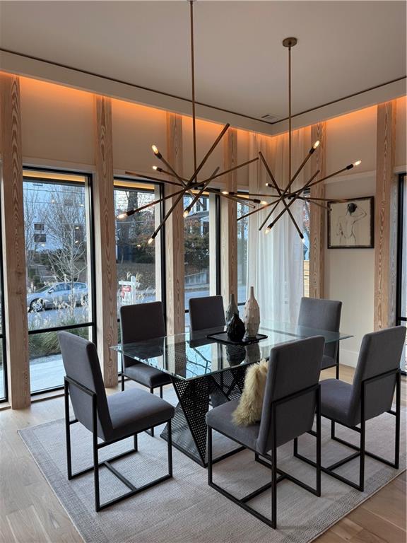 787 Bonaventure Avenue Northeast Atlanta, GA 30306 - Photo 7 of 64 a dining room with furniture a chandelier and wooden floor