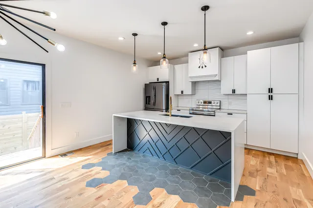 a kitchen that has a lot of cabinets in it