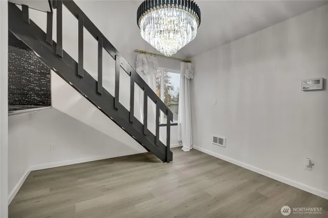 a view of an entryway with wooden floor