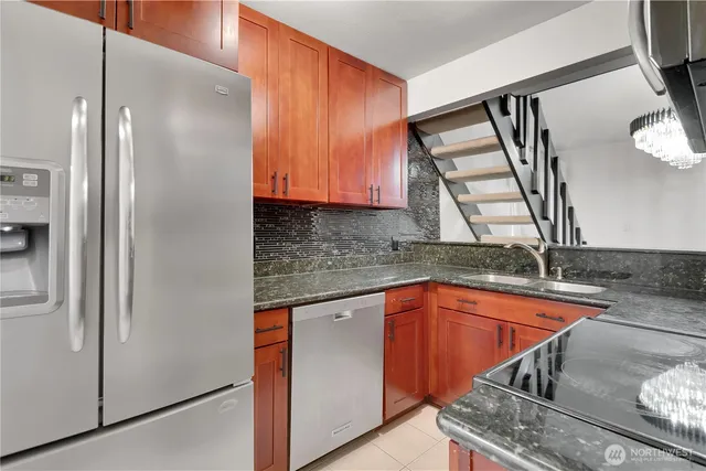 a view of a kitchen with stainless steel appliances granite countertop a refrigerator and a sink