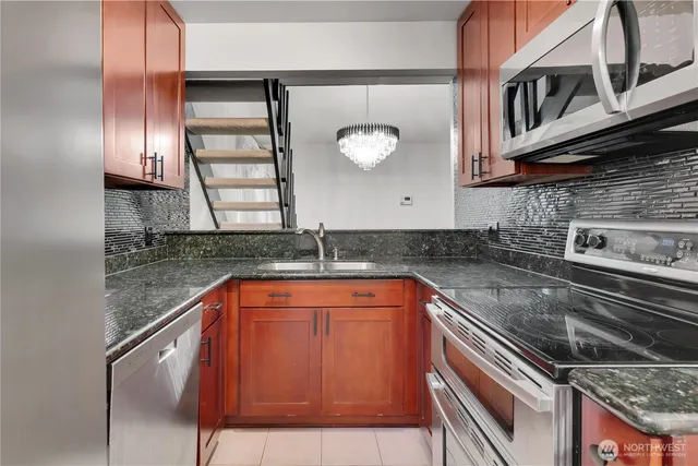 a kitchen with stainless steel appliances granite countertop a sink and a granite counter tops