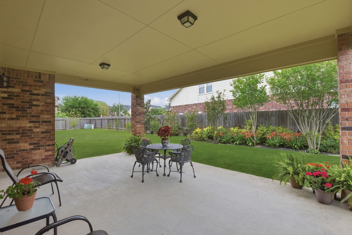 3301 Remington Rise Lane Katy, TX 77494 - Photo 41 of 50 a view of a patio with a table chairs and a yard