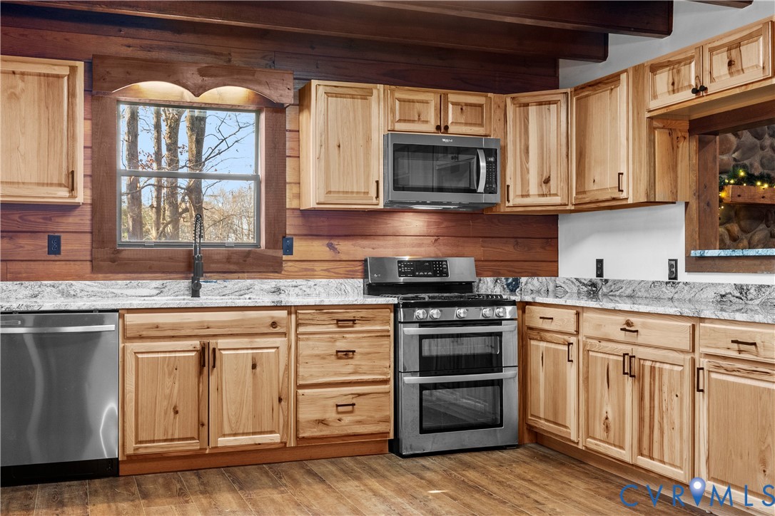45 Morningside Road Cartersville, VA 23027 - Photo 16 of 50 a kitchen with stainless steel appliances granite countertop a stove a sink and a microwave