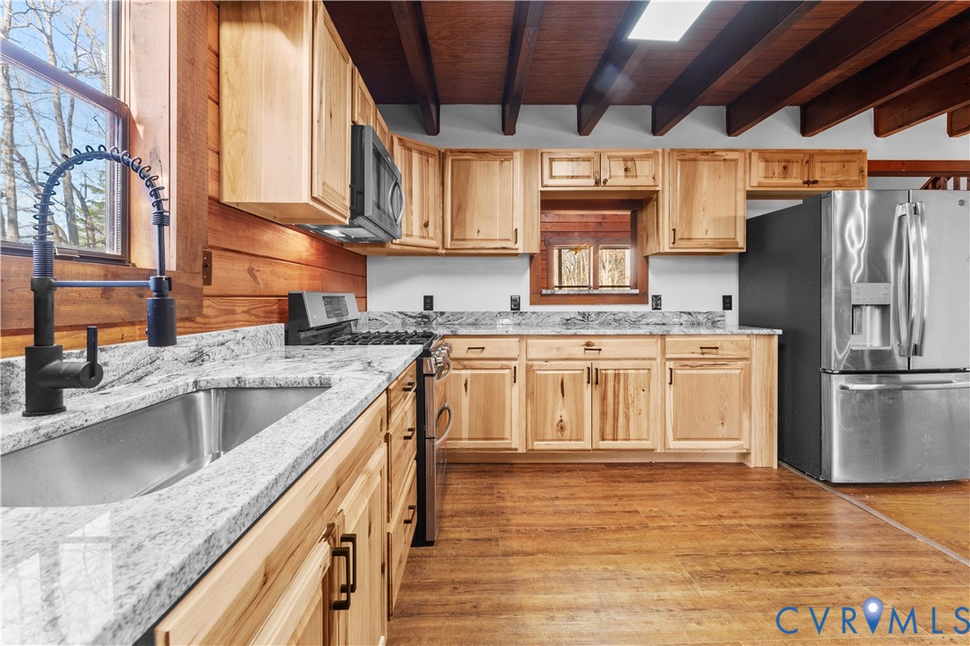 45 Morningside Road Cartersville, VA 23027 - Photo 18 of 50 a kitchen with stainless steel appliances granite countertop a sink a stove and a wooden floors
