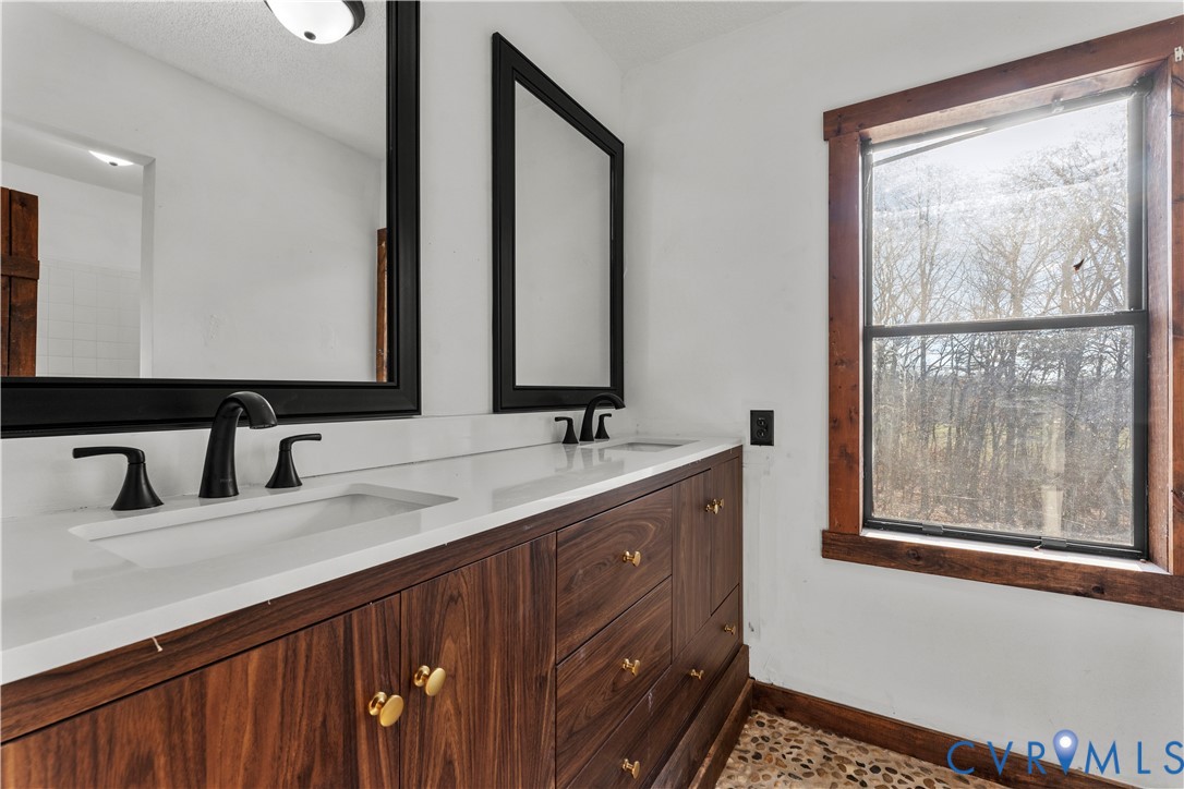 45 Morningside Road Cartersville, VA 23027 - Photo 39 of 50 a bathroom with a double vanity sink and a mirror