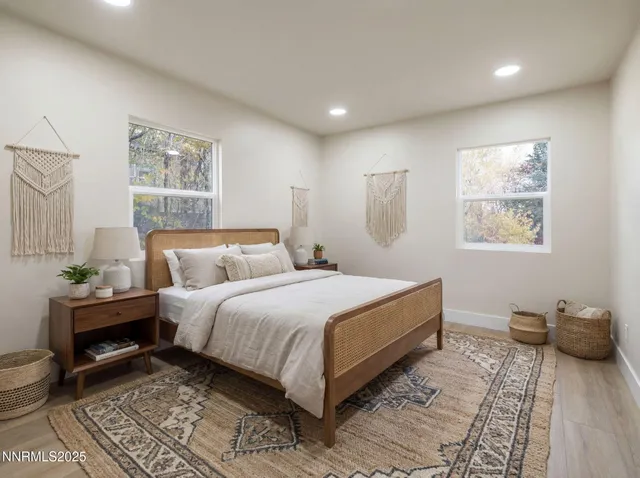 a bedroom with a bed and wooden floor