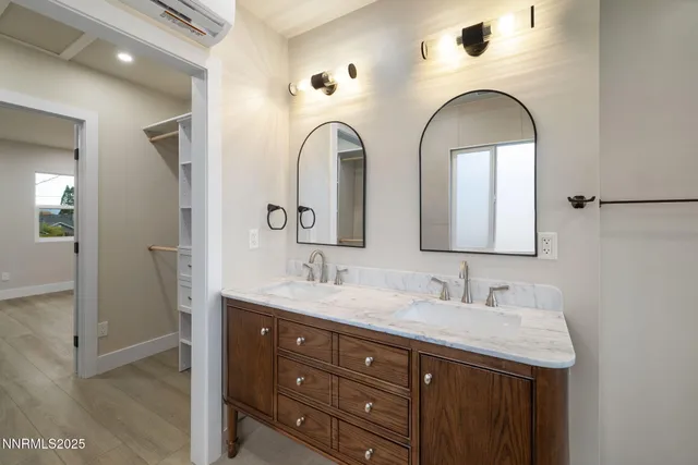 a bathroom with 2 sink and a mirror