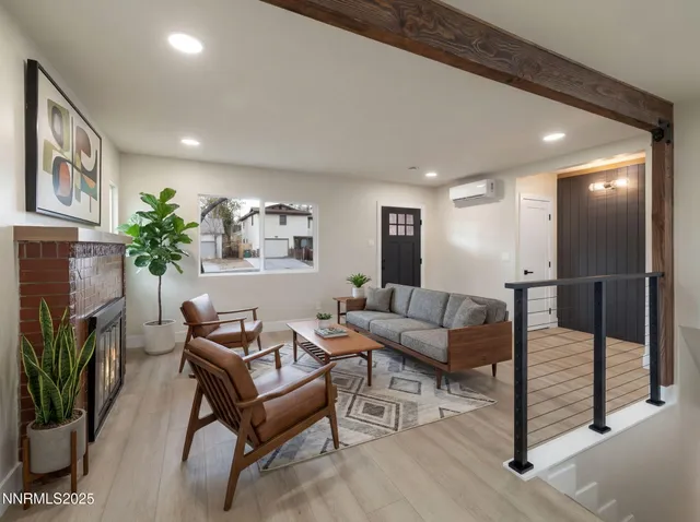 a living room with furniture a wooden floor and a fireplace