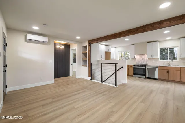 a view of kitchen with stainless steel appliances refrigerator and cabinets