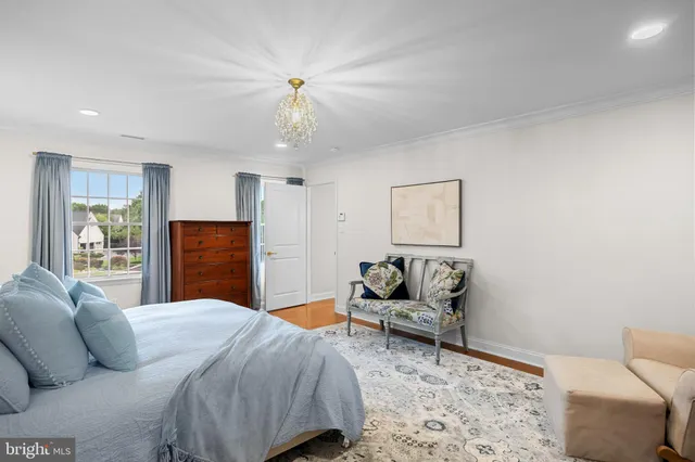 a bedroom with a bed couch and dresser