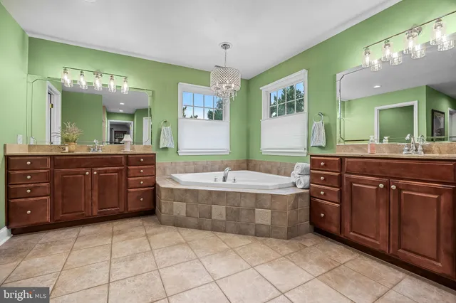 a bathroom with a tub sink and mirror