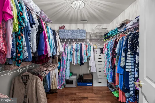 a view of walk in closet with clothes