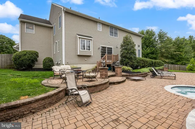 a view of a patio with chairs and plants