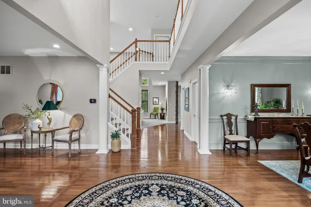 a living room with furniture and a table with wooden floor