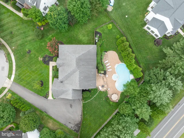 an aerial view of a house with a yard and trees