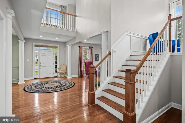 a view of a hallway with windows and kitchen view