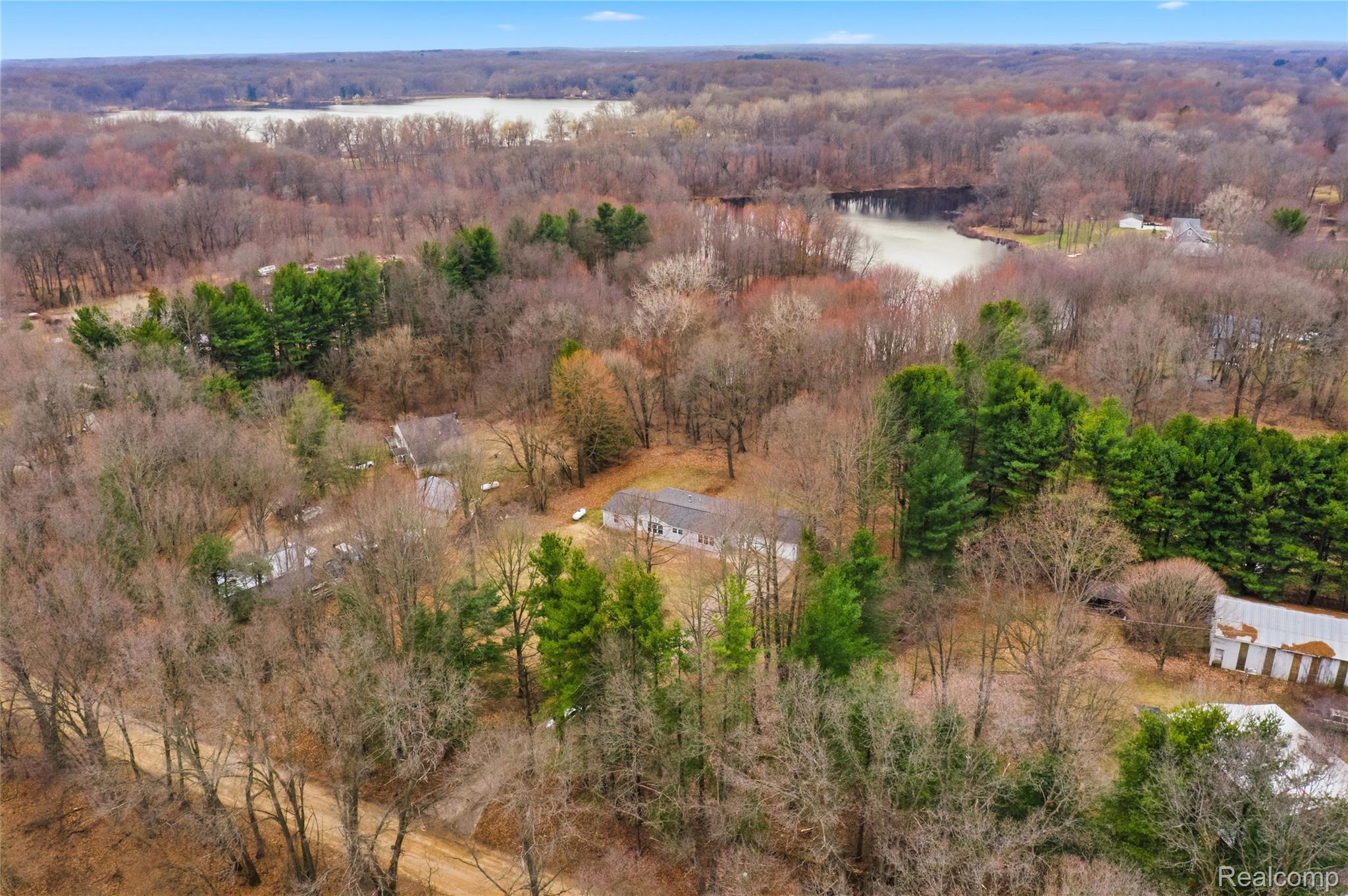 5350 List Road Grass Lake, MI 49240 - Photo 64 of 71 Aerial view of a forest and a nearby body of water
